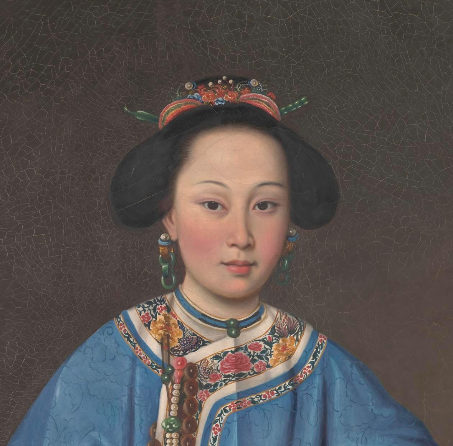 Portrait of an Asian woman wearing traditional blue embroidered clothing, elaborate hair ornaments, earrings, and a choker necklace.