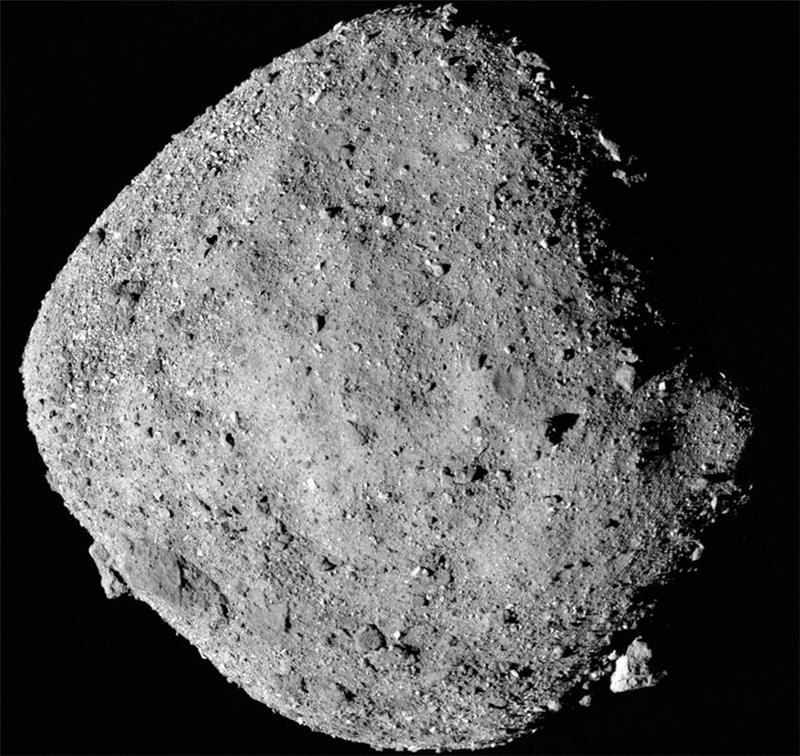 Asteroid Bennu, a near-Earth carbonaceous asteroid with a rough, cratered surface, against a black background.