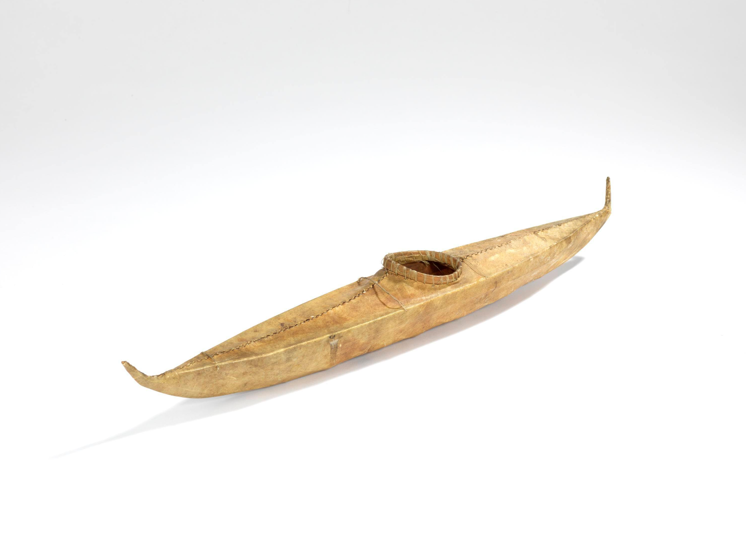 Modèle de kayak de 43 cm recouvert d'une peau marron clair cousue à l'aide de tendons.