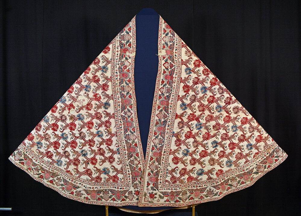 The front view of the completed cope on a display.
