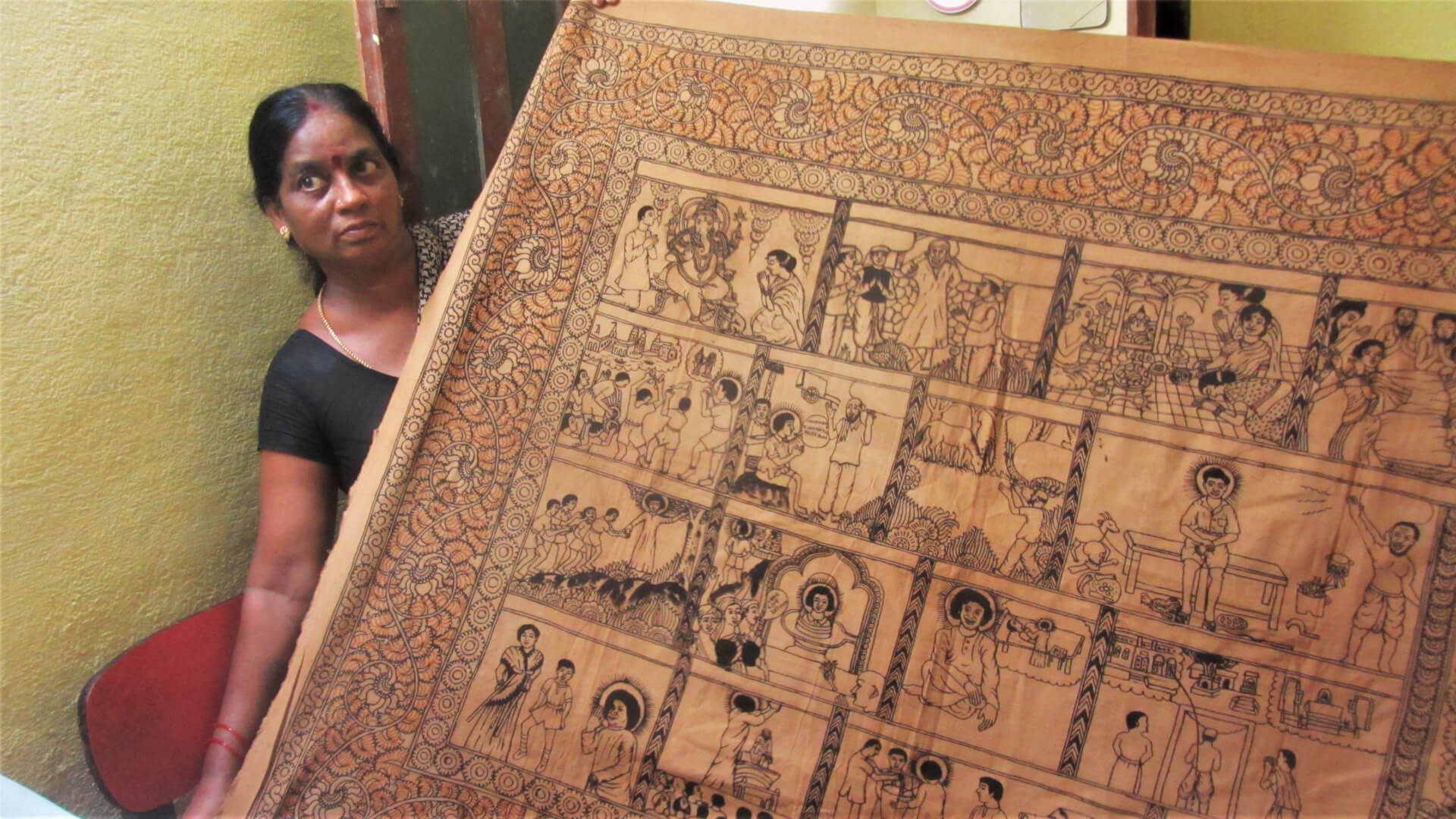 Woman holding a printed textile.