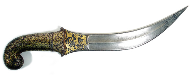 Antique curved dagger with an ornately decorated handle and blade.
