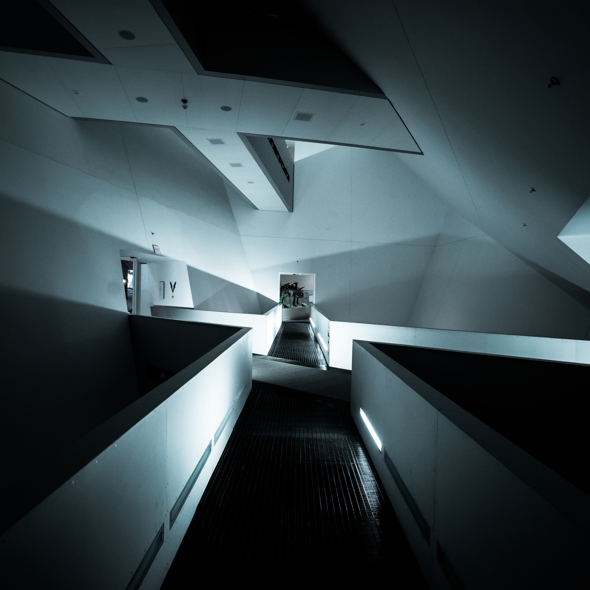 Interior architectural view of the Royal Ontario Museum’s Michael Lee-Chin Crystal with angular, white geometric walls and a central staircase.