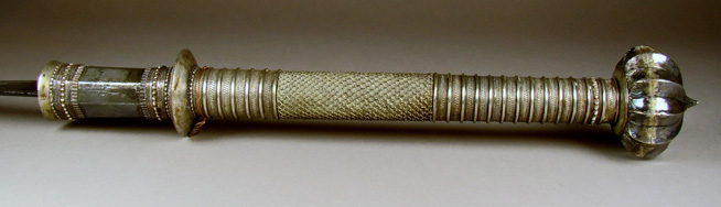 Ornate silver ceremonial scepter with detailed engravings and a rounded, decorative top.