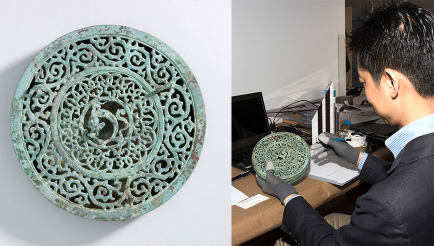 Circular greenish artifact with intricate floral and spiral patterns surrounding a central dragon figure.