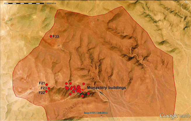 Map showing a cluster of red markers labeled with numbers near discovery buildings on a terrain with elevation shading.