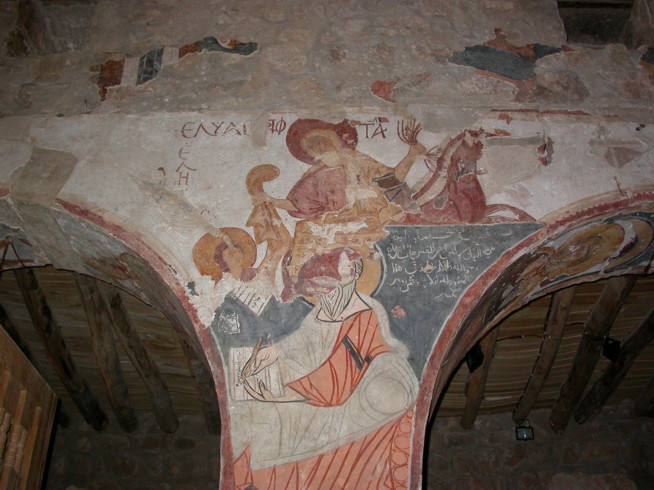 Faded fresco painting on a vaulted ceiling showing a central human figure surrounded by smaller figures and horses.
