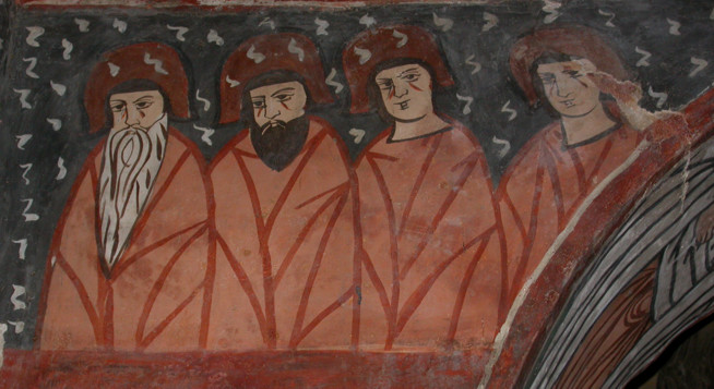 Medieval mural showing four men wearing red robes, with long beards and hats.