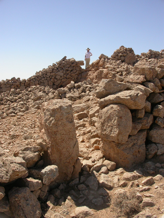 Rock formations made of stacked stones under a clear blue sky.