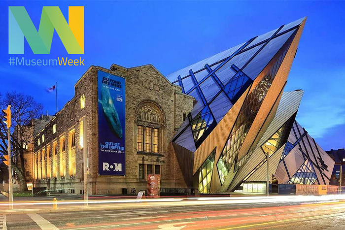 #MuseumWeek logo in yellow and blue over a photo of the Royal Ontario Museum exterior at dusk with illuminated angular glass structures and banners reading "ROM".