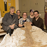 Photo of five people behind the tail specimen
