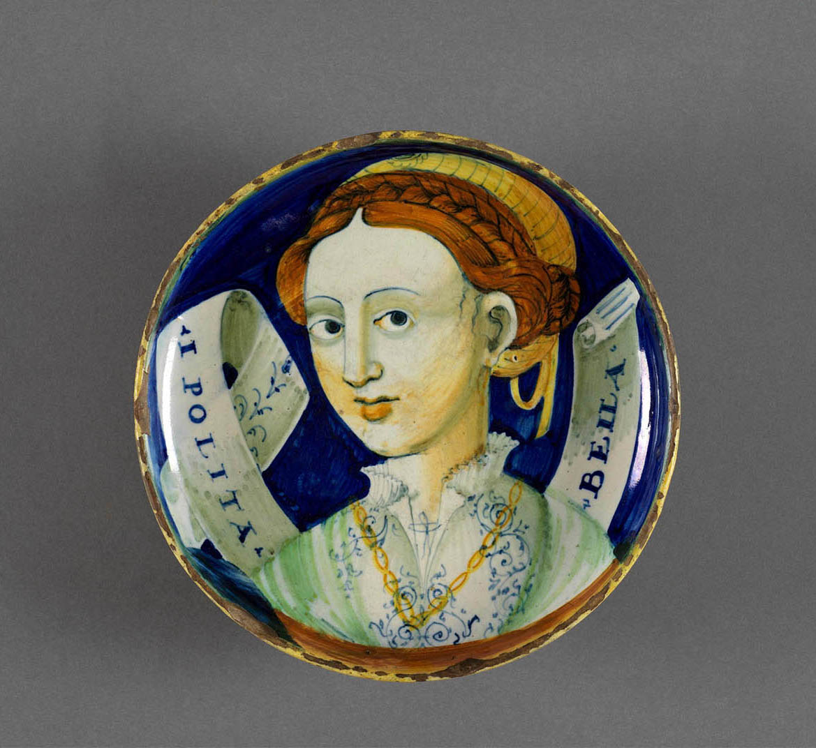 Italian pottery plate with a woman painted on it.