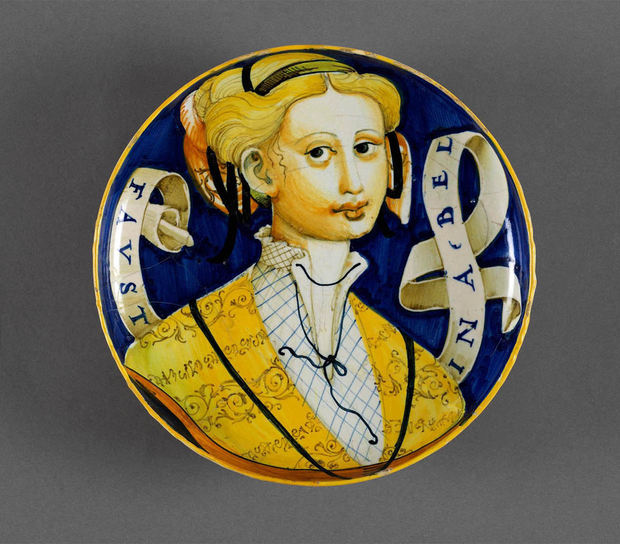 Italian pottery plate with a woman painted on it.