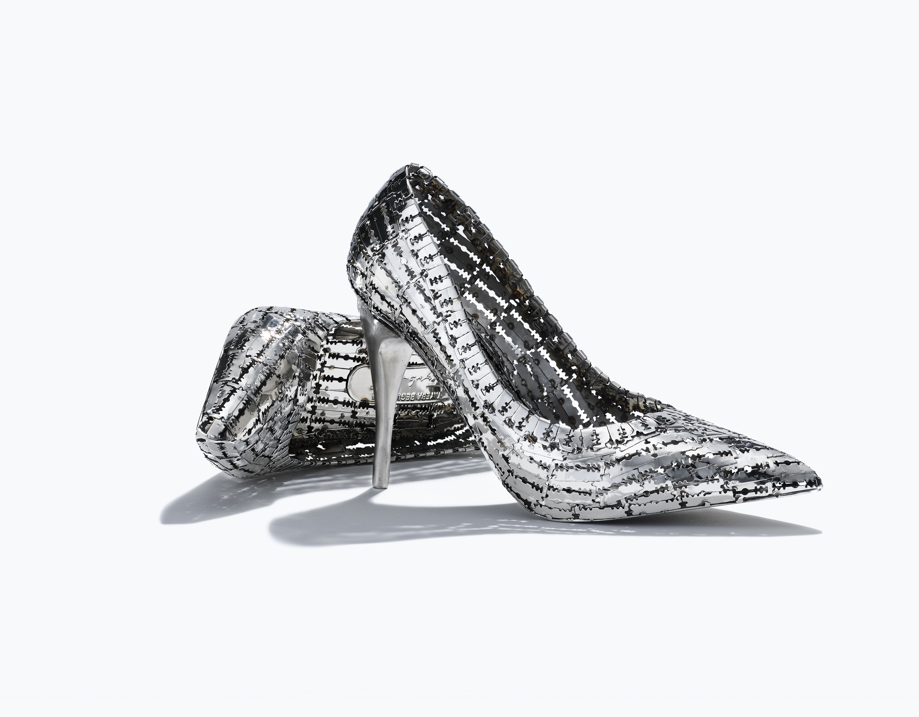 Two high heels made of razorblades