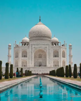 A white building with a dome and four towers
