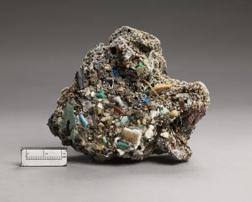 Rough, irregular mineral specimen with turquoise and white crystalline formations, shown next to a 5 cm scale.