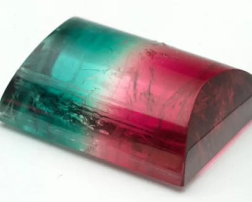 Polished rectangular gemstone with a gradient of green transitioning to pink.