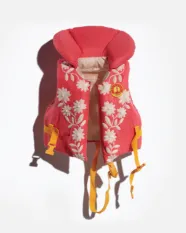 Red life jacket with white floral designs and yellow straps.