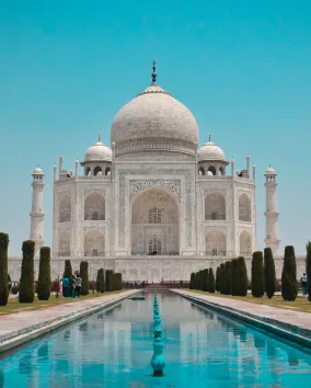 A white building with a dome and four towers