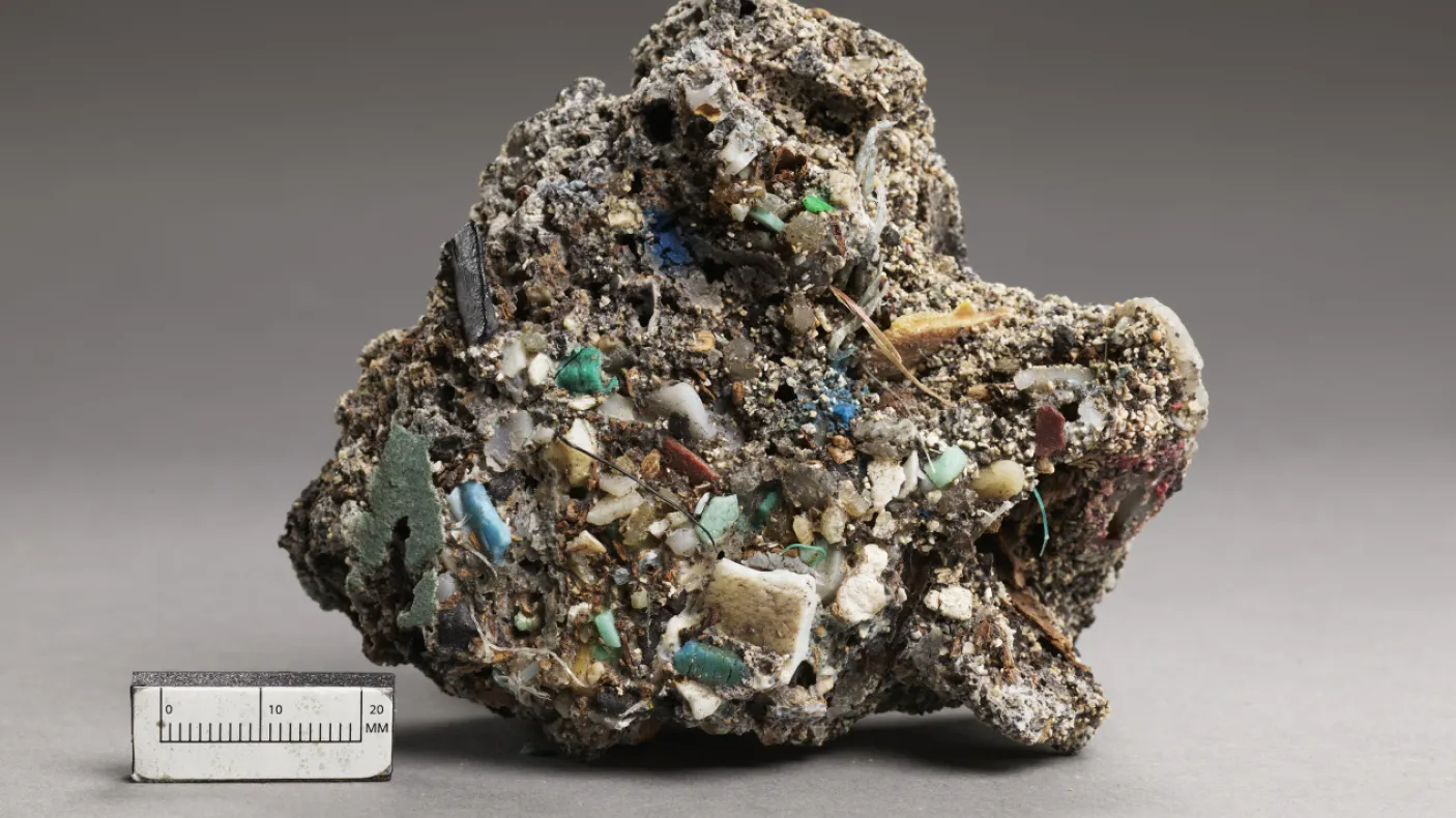 Rough, irregular mineral specimen with turquoise and white crystalline formations, shown next to a 5 cm scale.