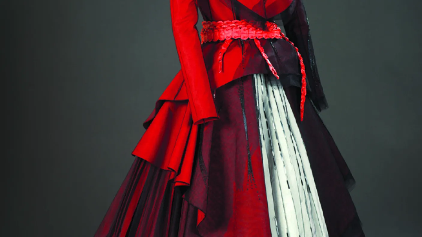 Red dress with white panels and black beaded designs
