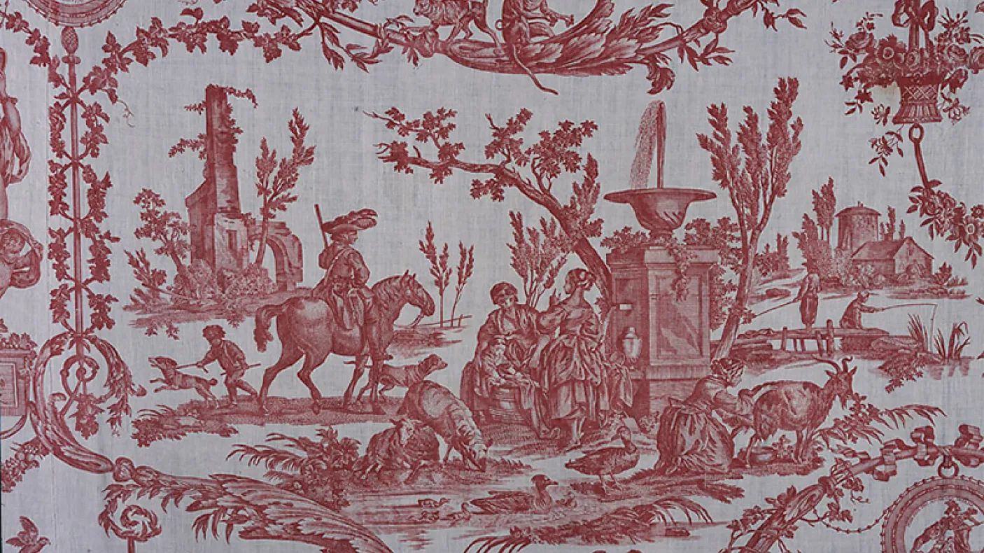 Red toile fabric pattern showing pastoral scenes with people riding horses, trees, and classical urns.