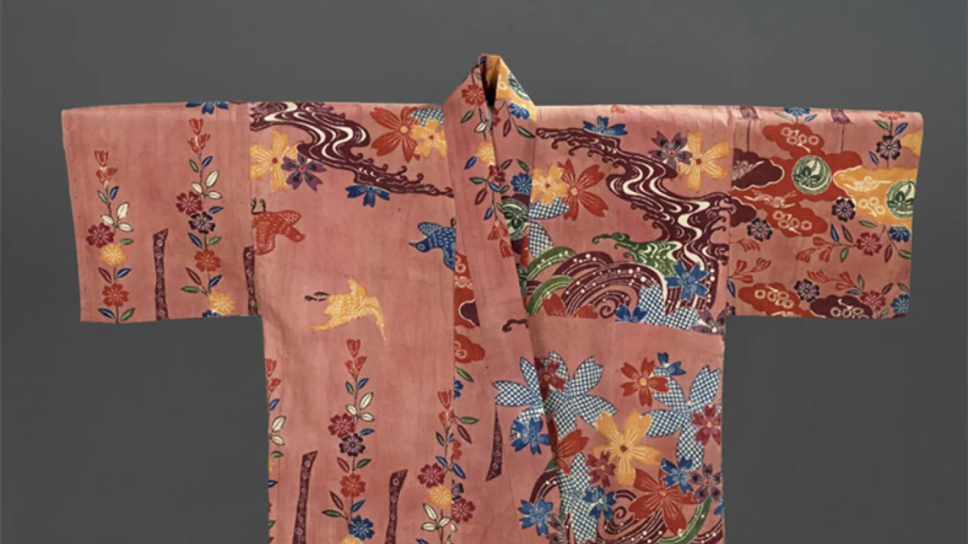 Silk Chinese robe with embroidered floral and bird motifs on a pink background.