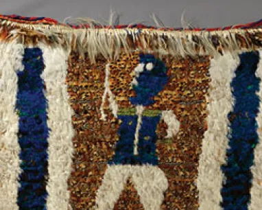 Rectangular woven textile with a central figure in blue and white, flanked by two vertical blue stripes on a brown background.