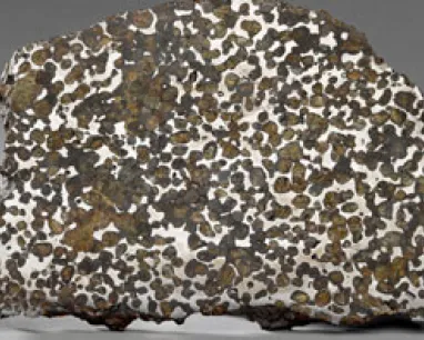 Slice of iron meteorite with a distinctive pattern of interlocking silver crystals and brown rust-colored patches.