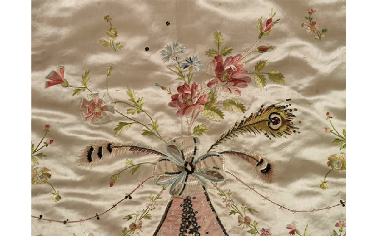Overdress of a robe en fourreau. Attributed to Marie-Jean "Rose" Bertin (French couturière, 1747-1813). France. 1780's, altered in 1870's. Embroidered satin with ribbon appliqués, sequins, faceted glass stones mounted on silver facings, and silver filé; fitted, boned bodice. 925.18.3.A.