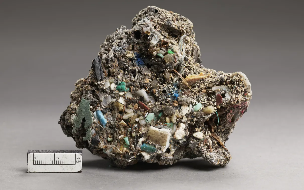 Rough, irregular mineral specimen with turquoise and white crystalline formations, shown next to a 5 cm scale.
