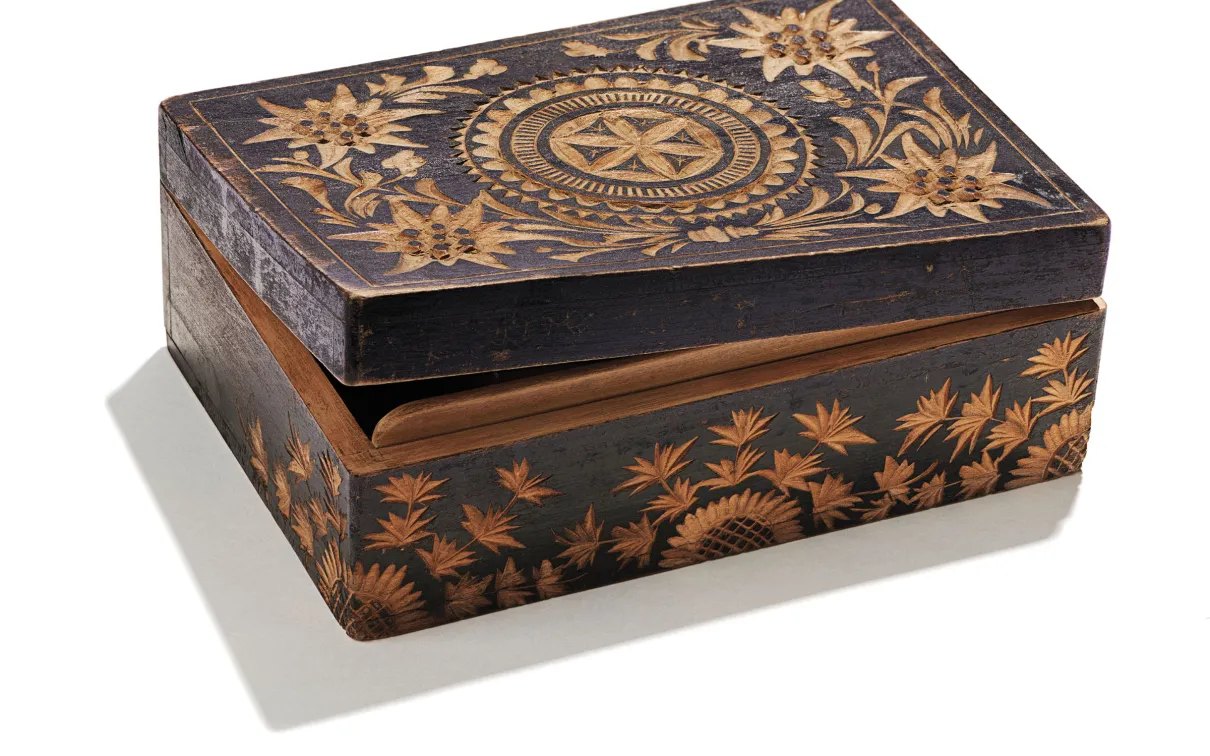 Wooden box decorated with floral and circular star-patterned inlays.