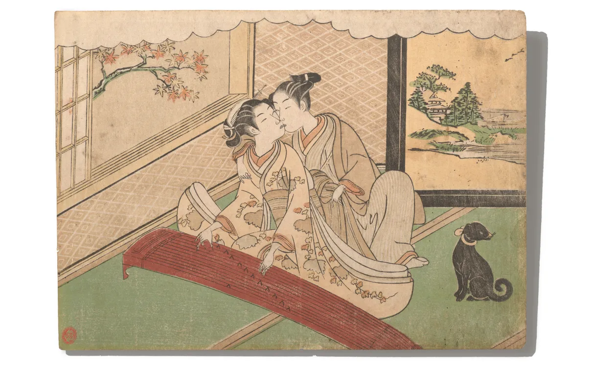 Two women in traditional Japanese clothing seated indoors on tatami mats, one playing a koto instrument, with a black cat nearby and a painted screen of a landscape behind.