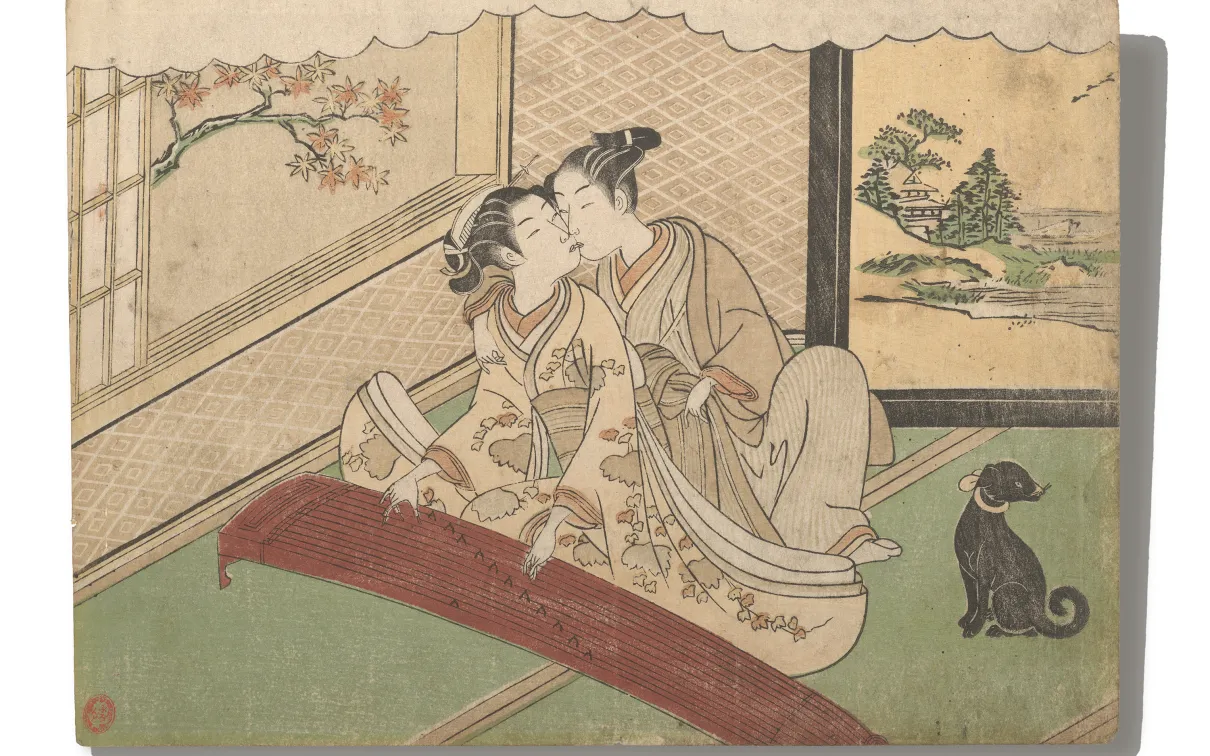 Two women in traditional Japanese clothing sitting on a tatami mat floor near a low table, with a black dog nearby.