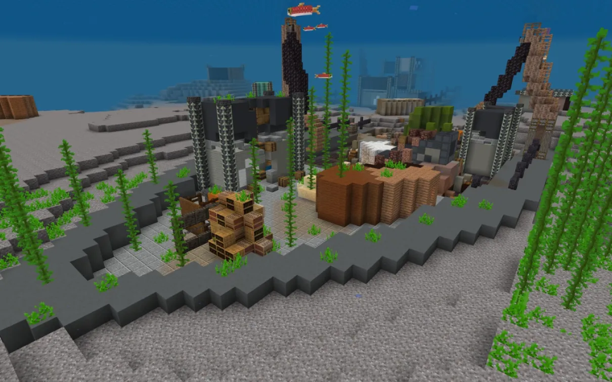 A Minecraft screenshot of a sunken cargo ship with fish swimming around crane arms and broken cargo containers
