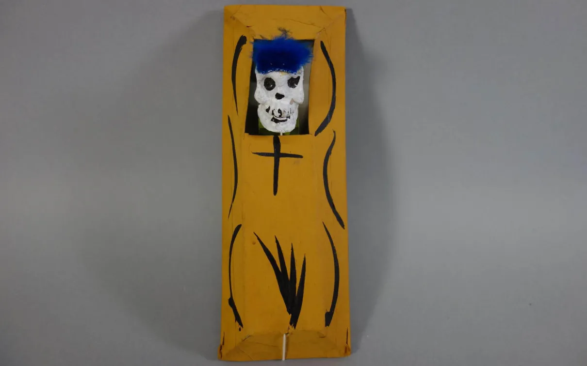 Yellow rectangular object with black curved lines and a small white skull at the top.