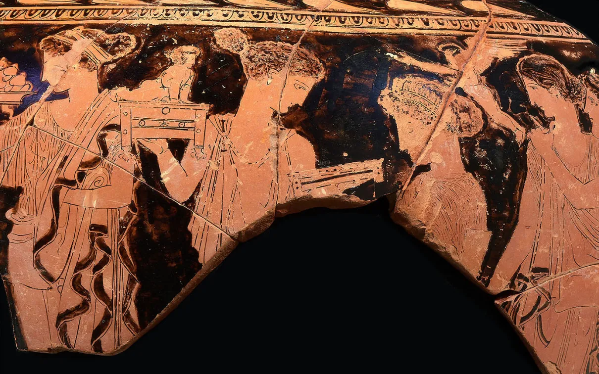 Fragment of a red-figure Greek vase showing three draped human figures, with one holding a staff or spear.